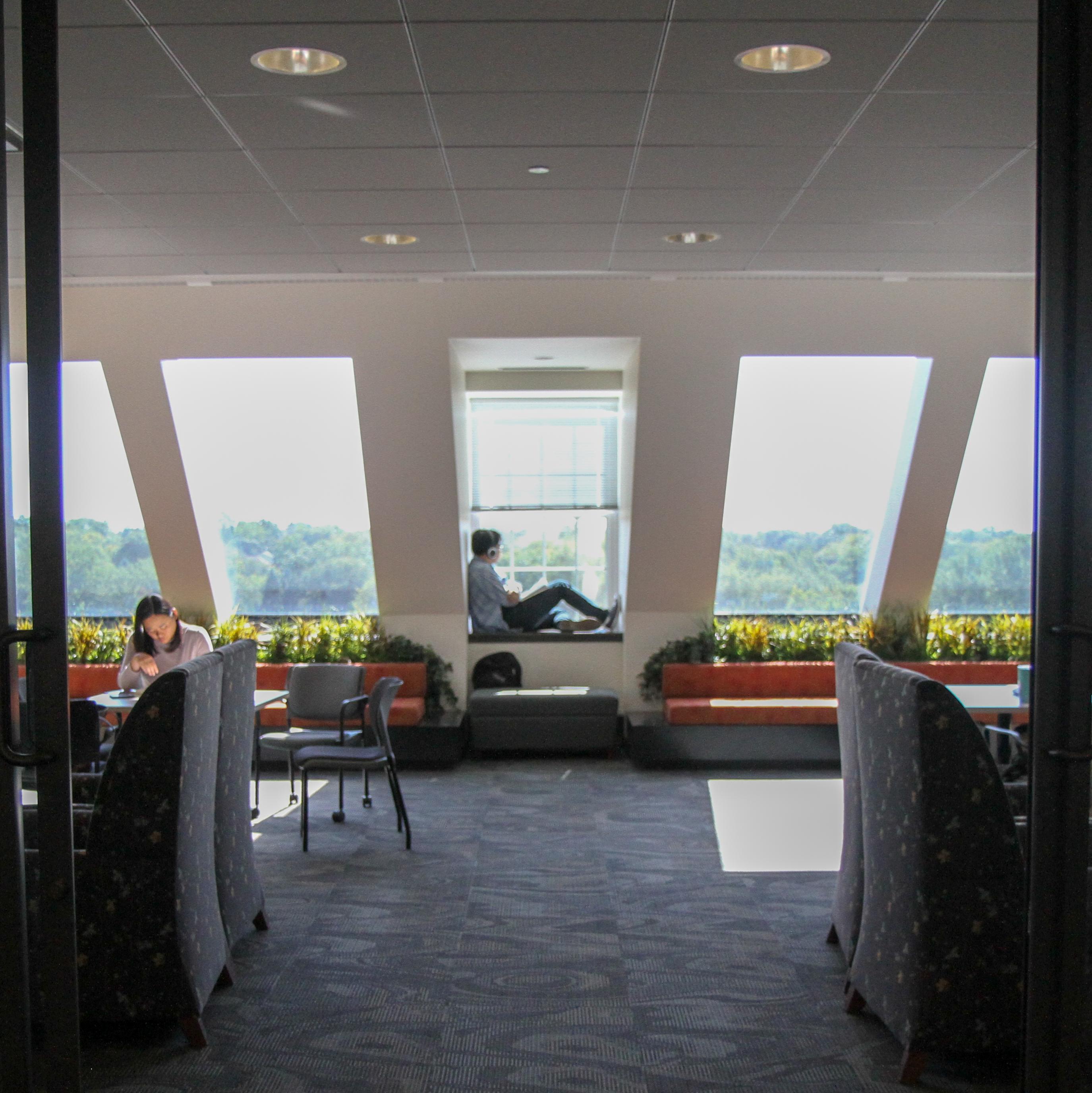 Student sitting on the window sill in the Billy Graham center