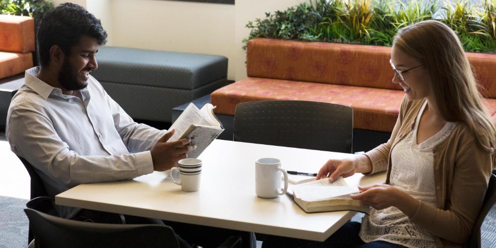 Students reading the Bible at a table