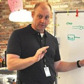 Dr. Carroll-teaching in front of white board