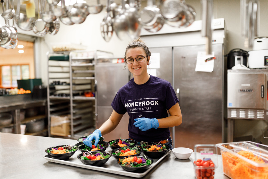 Student Fixing Salads in HoneyRock Kitchen