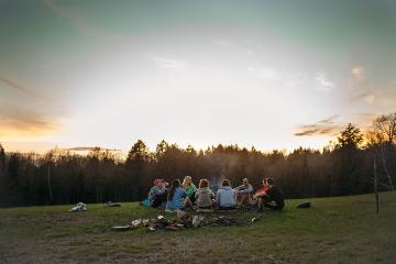 group of vanguards around a campfire at honeyrock in three lakes wi