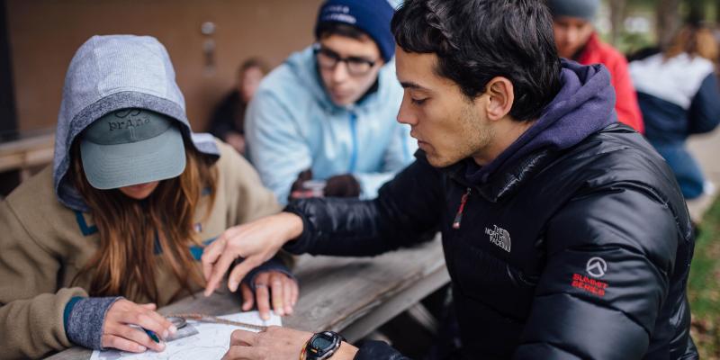 student leading student through orienteering at HoneyRock in Three Lakes, WI 