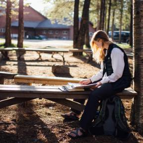 student studies outside at HoneyRock in Three Lakes, WI