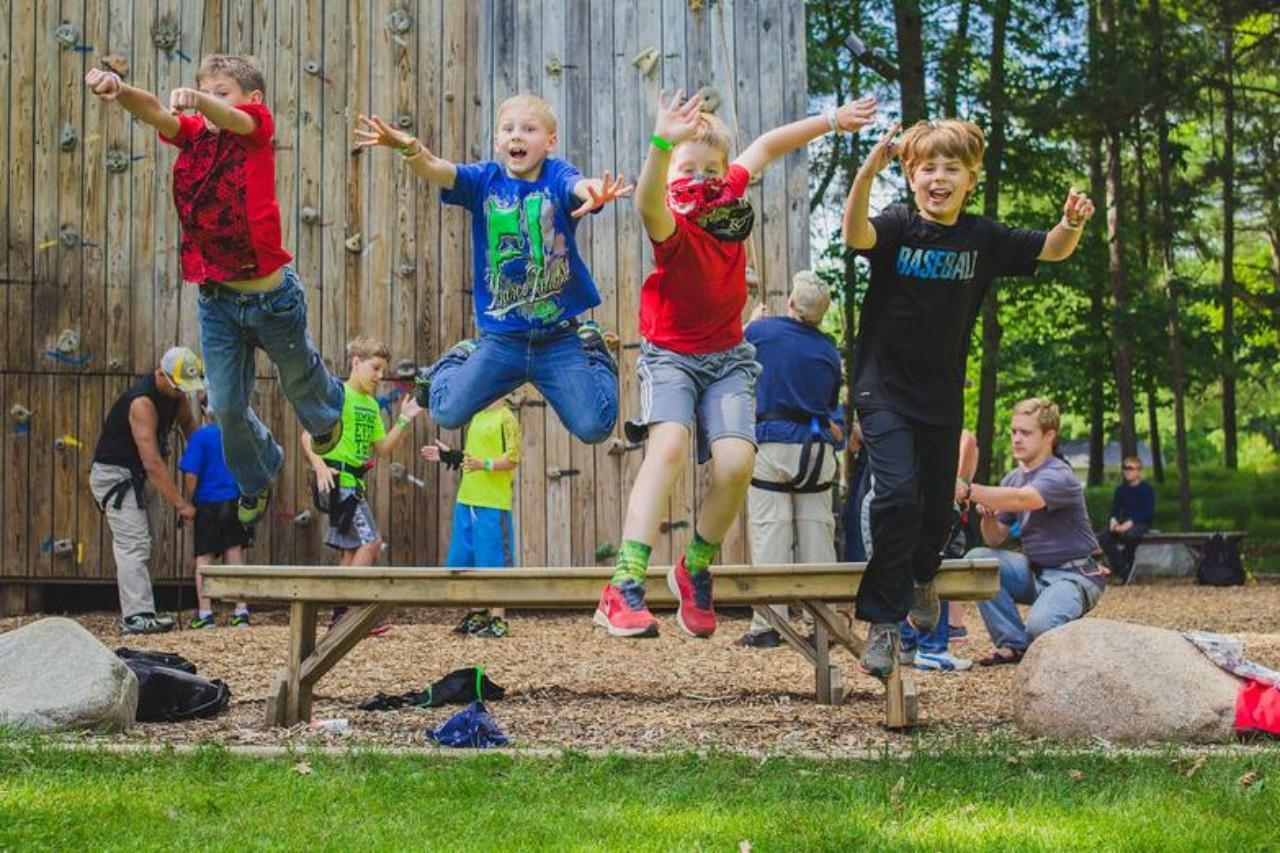 boys jumping off bench at HoneyRock in Three Lakes WI