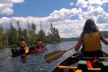 campers canoe in Boundary Waters in Minnesota during HoneyRock wilderness trip