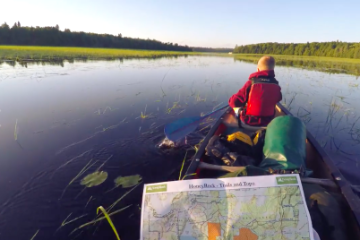 campers reading a map as they're canoeing at HoneyRock