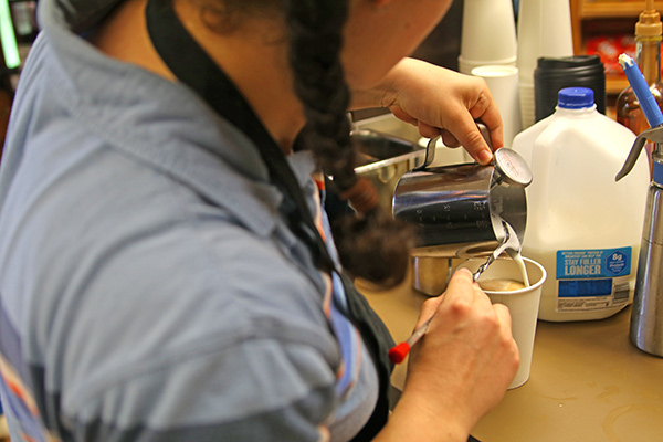 Barista pouring coffee