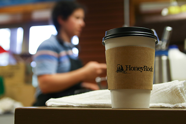 Coffee cup with student in background