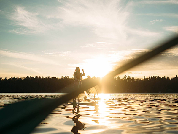 Student on water at sunrise Honeyrock