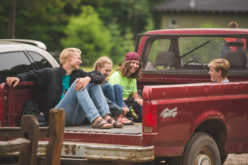 Service team campers in back of pickup truck at HoneyRock camp in Three Lakes WI