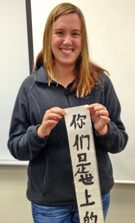 Student with scripture scroll in Mandarin Chinese