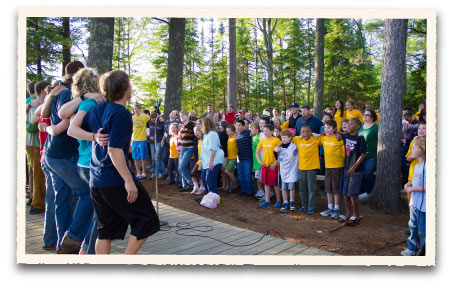 Campers and counselors join in an energizer activity at HoneyRock's Cathedral Pines 