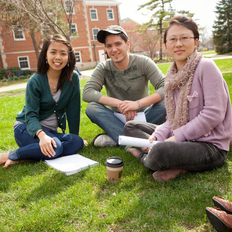 Students sitting on the lawn at Wheaton College IL